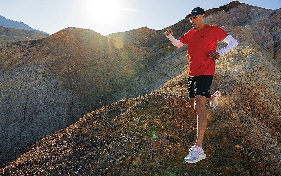 Man wearing Columbia Sportswear gear running down a rocky hill. 