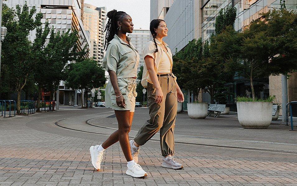 Two women wearing Columbia Sportswear Everyday Outdoor collection walking through a city downtown. 