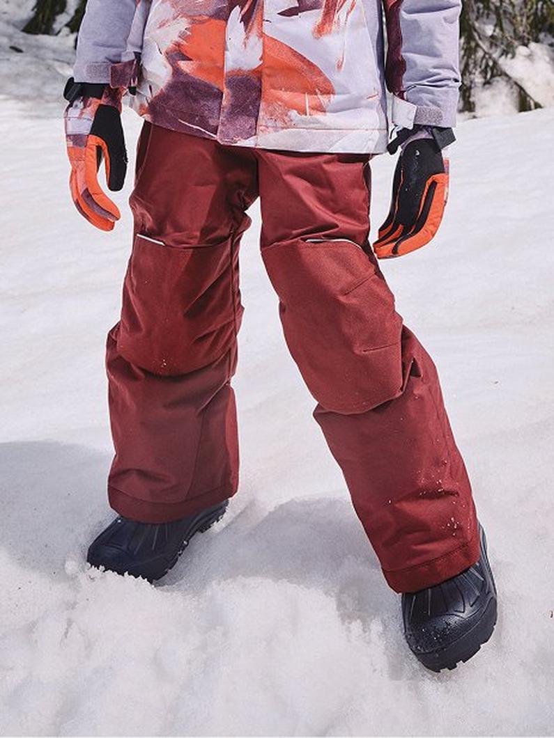 Child wearing snow pants.
