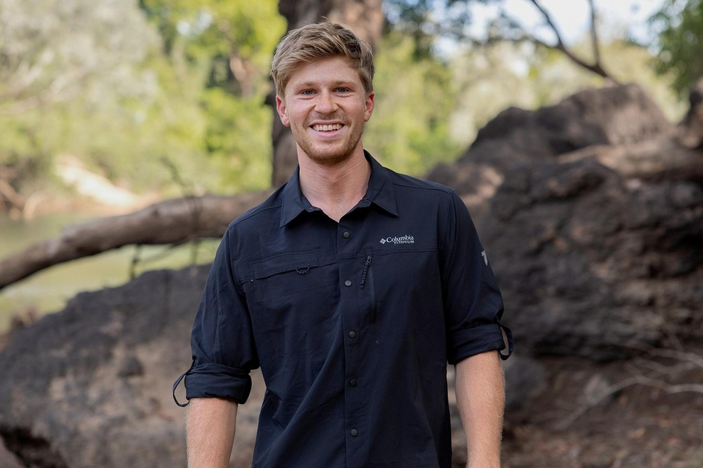 Robert Irwin smiling in the woods.