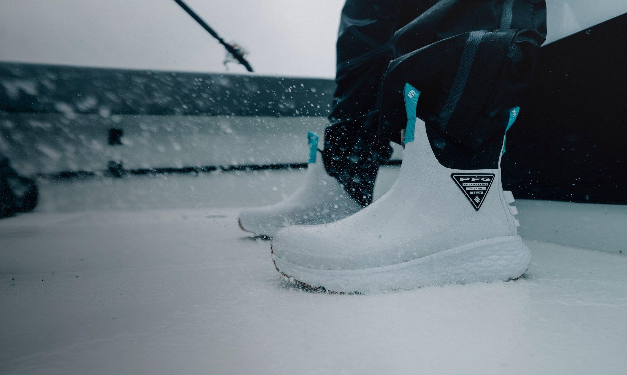 Water splashing on white deck boots with teal accents. 
