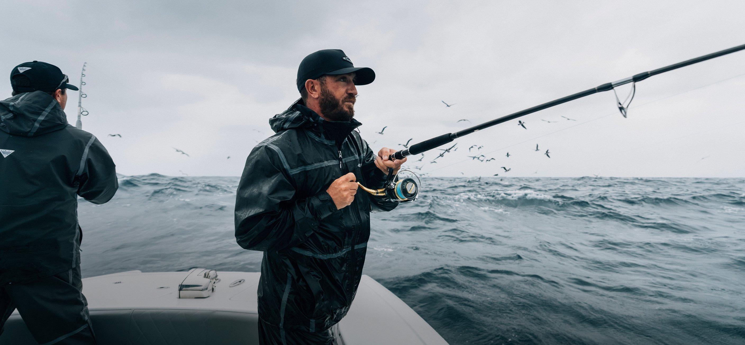 Man wearing PFG rain gear on a boat.