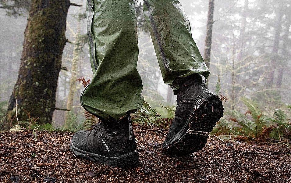 A close up of a person in Columbia Sportswear rain pants and Columbia Facet Hiking shoes. 