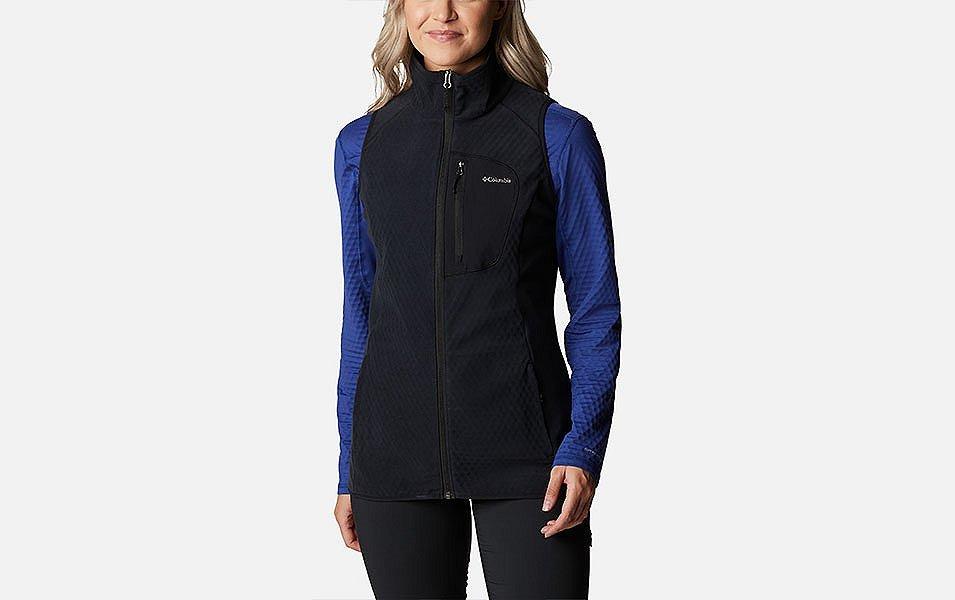 A product image of a woman wearing Columbia Sportswear’s Outdoor Tracks Vest against a white background. 