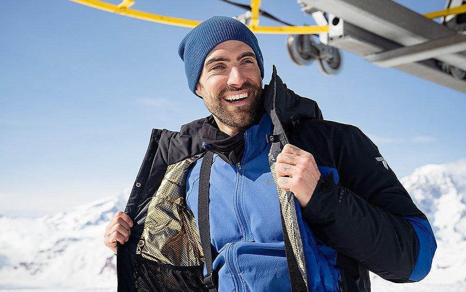 A man Shows the gold lining of his Columbia Sportswear Omni-Heat Infinity jacket. 