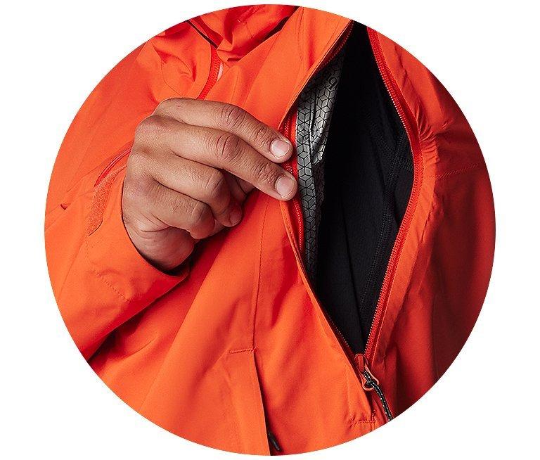 Someone sliding a card out of a sleek jacket pocket.