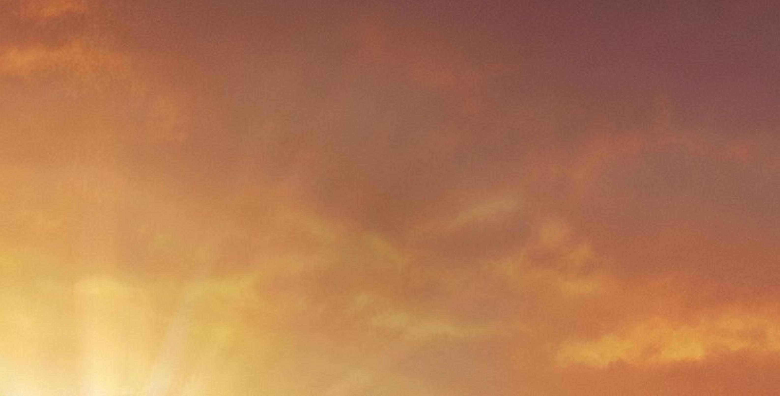 Sun shining against cloudy sky