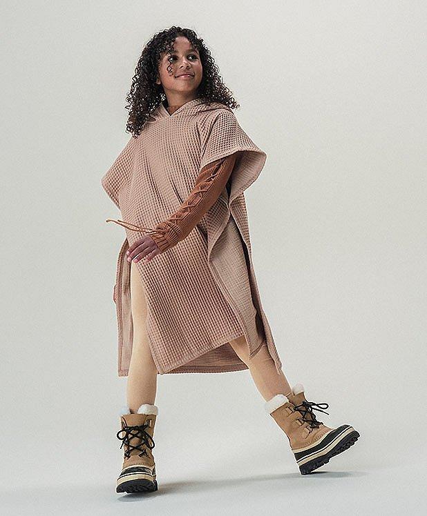 A youth wearing Sorel Shoes