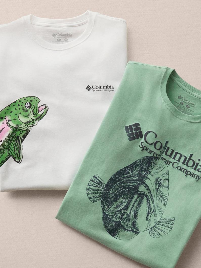Two folded t-shirts featuring fish graphics, one white with colorful fish, one green with black fish print.