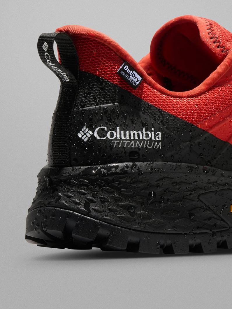 Close-up of athletic shoe heel with water-resistant black and red mesh upper and rugged tread sole.