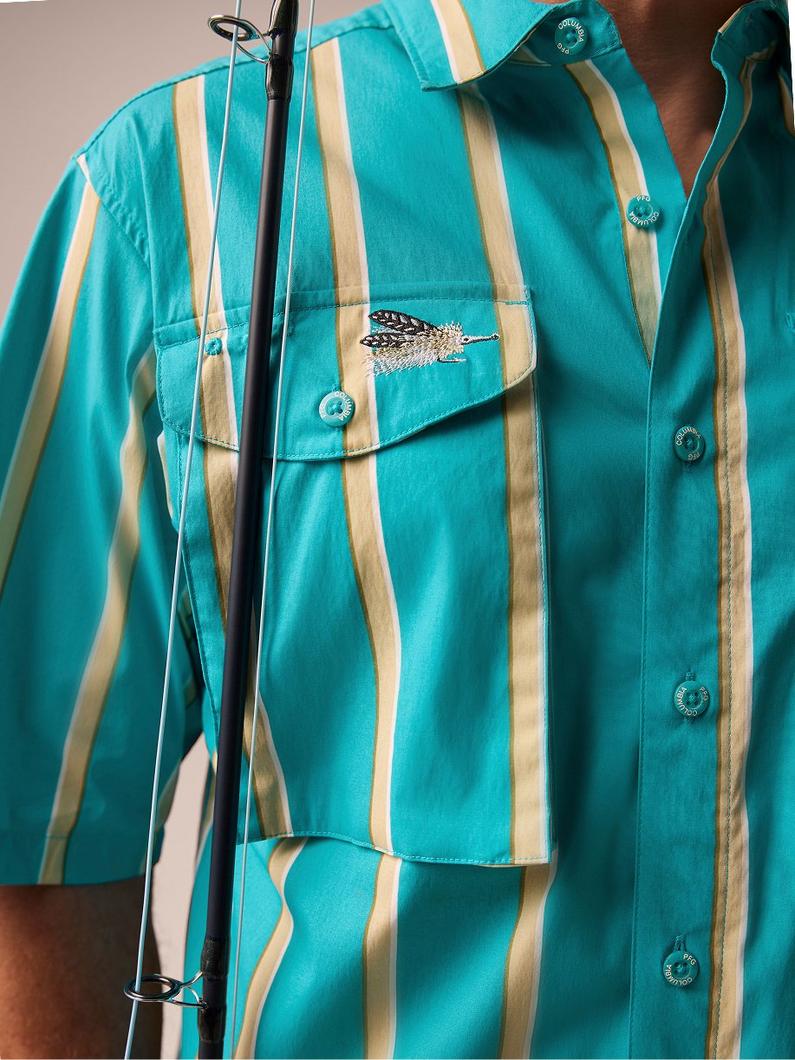 Turquoise and tan vertical striped shirt with chest pocket featuring embroidered logo detail on hanger.