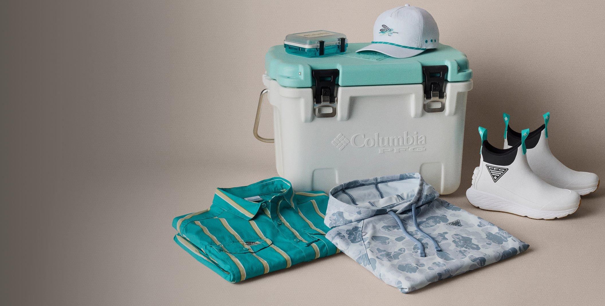 White cooler with turquoise lid displaying outdoor gear including folded shirts, white cap, and rain boots.