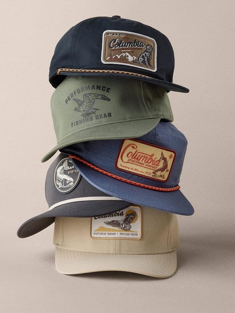 Four baseball caps stacked vertically featuring outdoor-themed patches with mountain and fishing graphics.