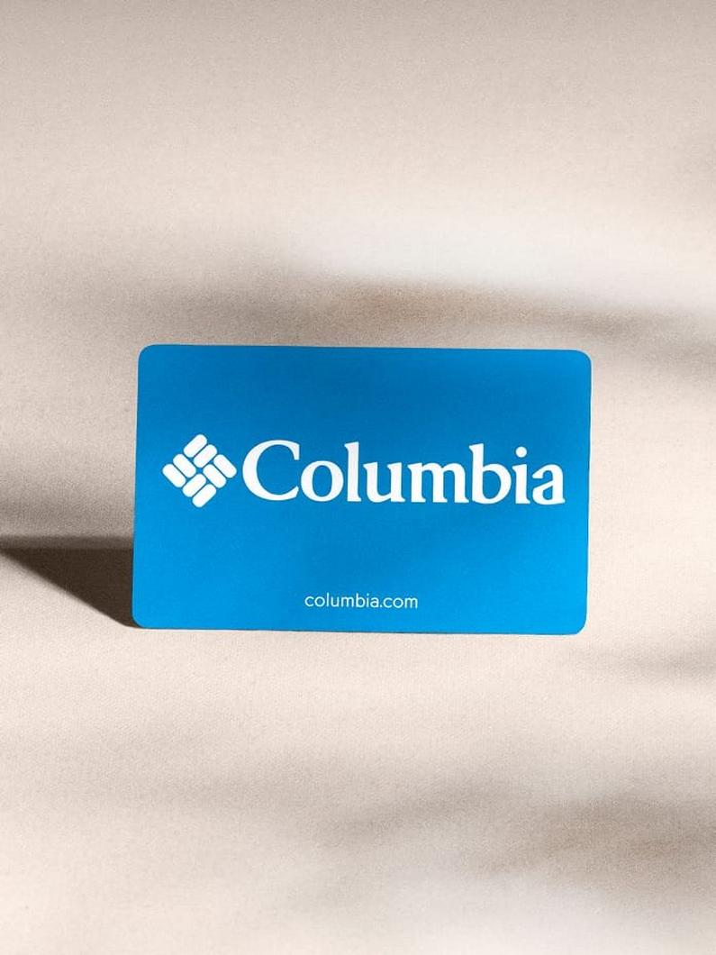 Blue gift card on a beige fabric surface with website text columbia.com displayed.