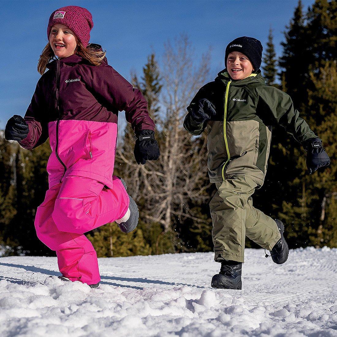 A mom and her daughter sledding.