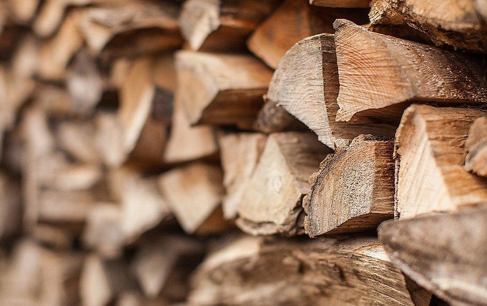 Well-stacked firewood is ready for the campfire. 