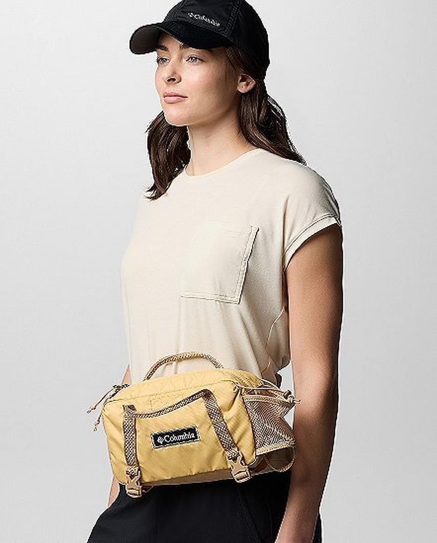A woman wearing a yellow hip pack.