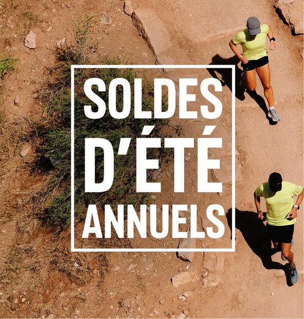 Overhead view of two people running on a dirt trail wearing yellow athletic shirts and black shorts.