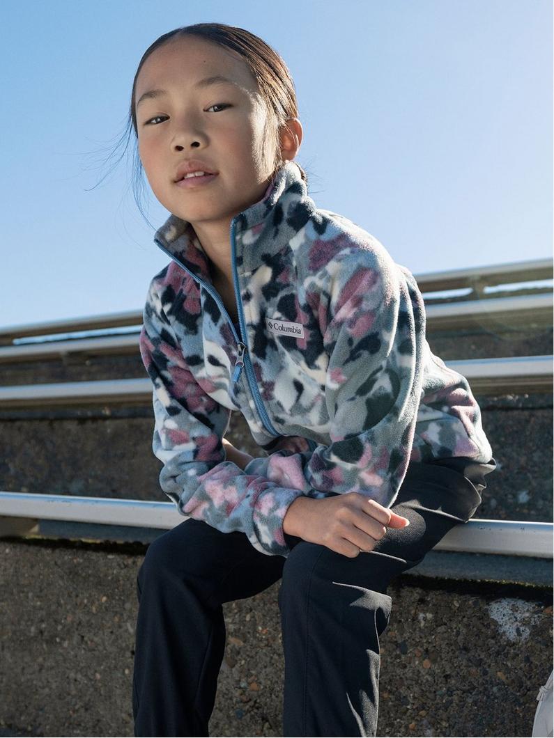 Child wearing a multi-colored floral fleece quarter-zip pullover outdoors.
