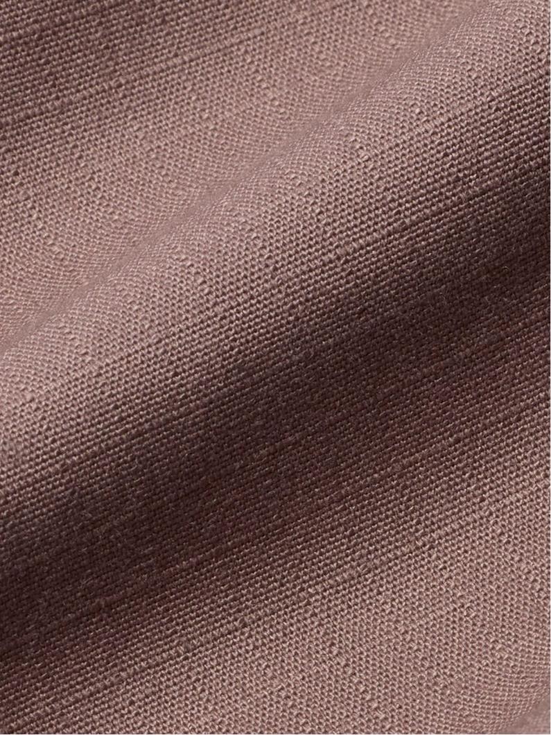 Close-up of brown woven fabric texture with diagonal twill weave pattern and natural variations in tone.