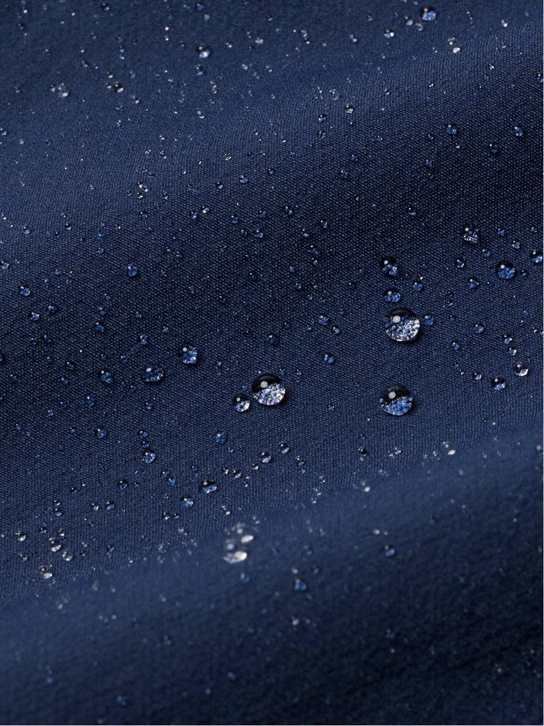 Water droplets beading on navy blue water-resistant fabric showing waterproof protection.
