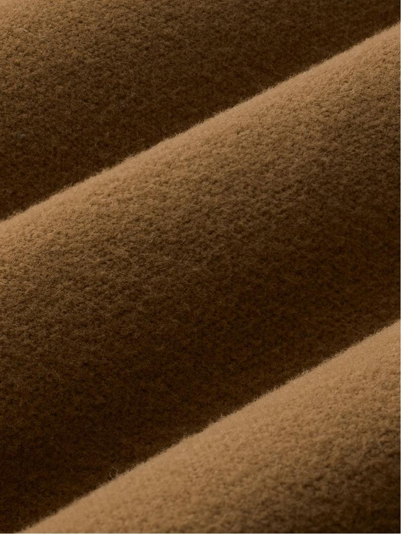 Close-up of soft wool fabric showing diagonal stripes in brown and tan with visible textured weave.