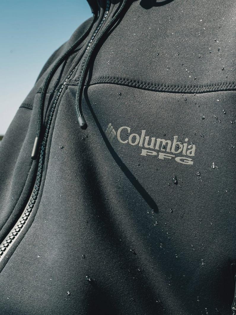 Dark gray water-resistant jacket with zippered chest pocket and drawstring hood, showing water beading.