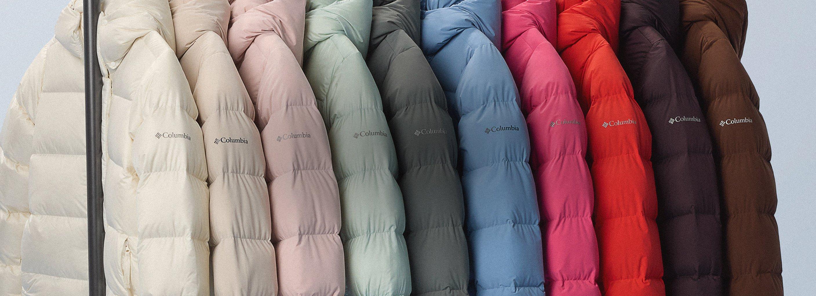 Row of quilted puffer jackets displayed in multiple colors from cream to pink, mint, gray, blue, red, and brown.