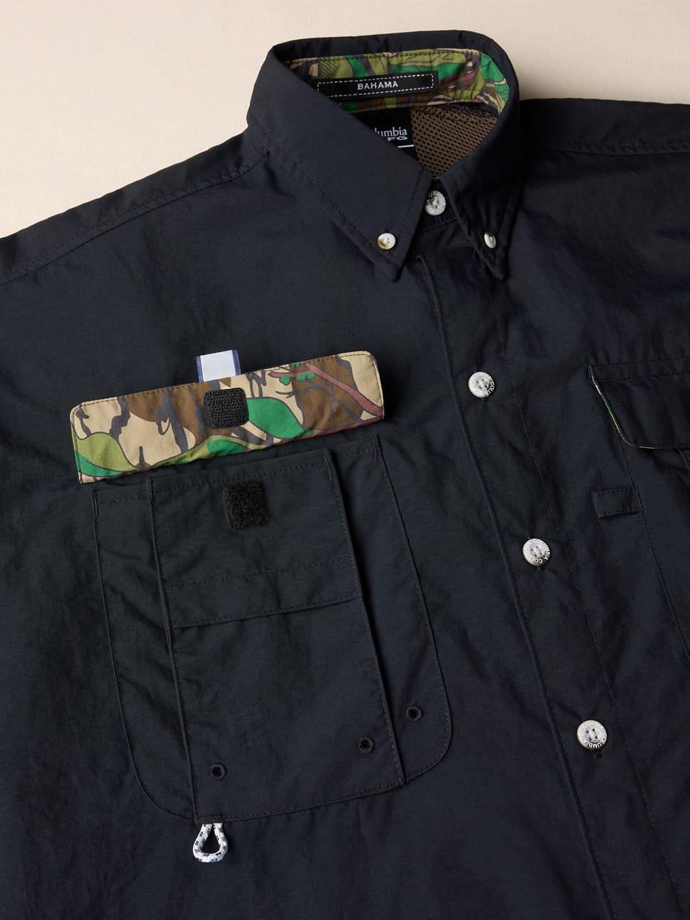 Black button-down shirt with camouflage trim accents and multiple chest pockets with snap closures.