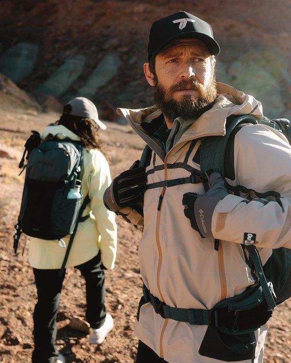 Two hikers wearing Titanium gear in a rocky landscape.