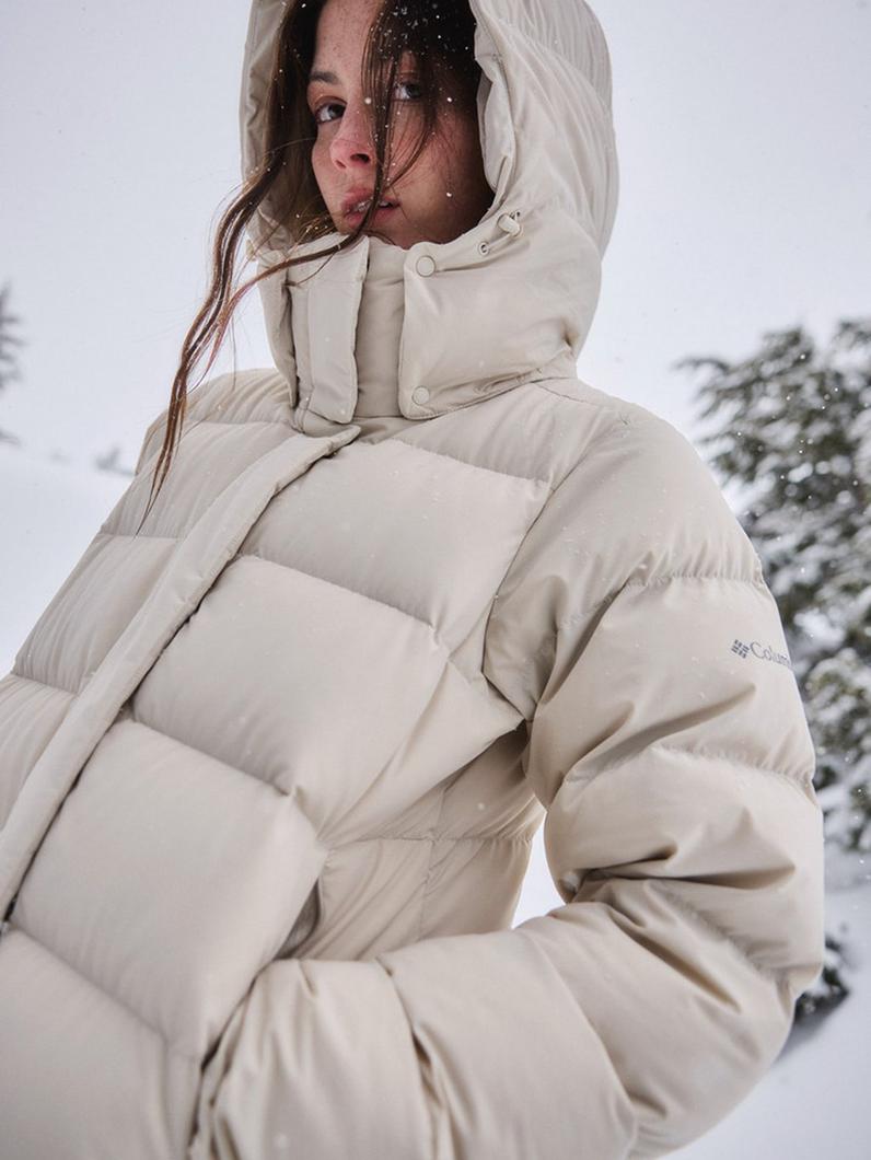 A woman wearing a puffy white jacket.
