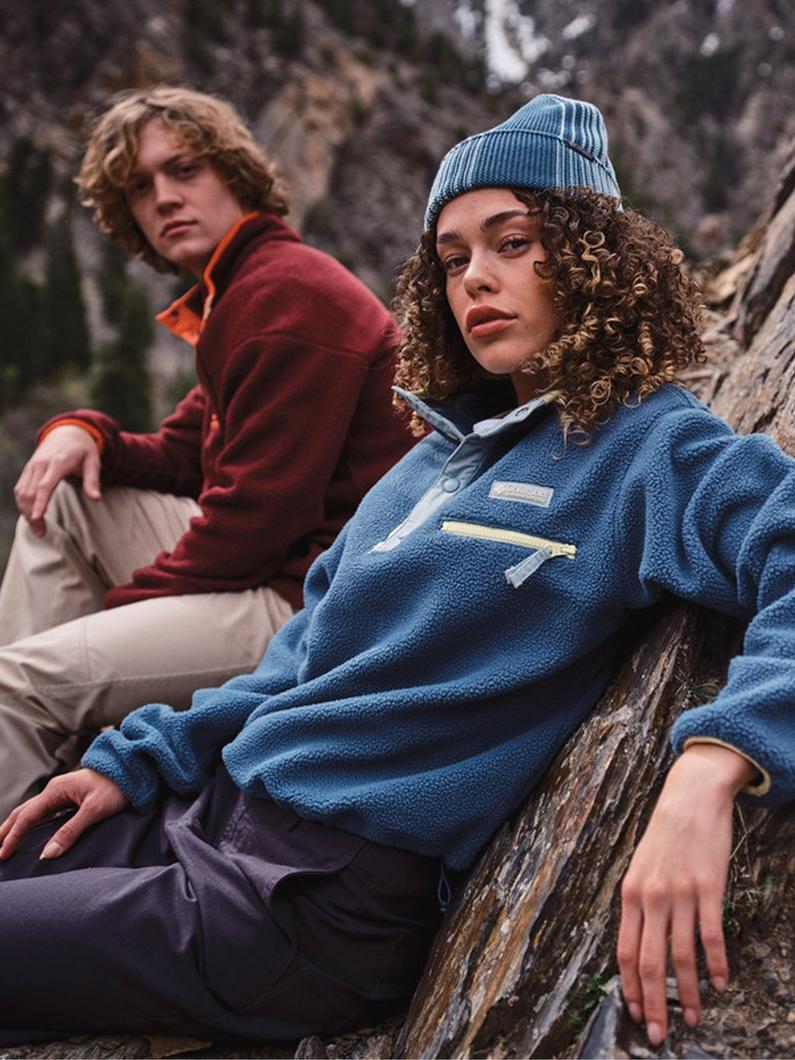 Two hikers wearing fleece in a rocky landscape.