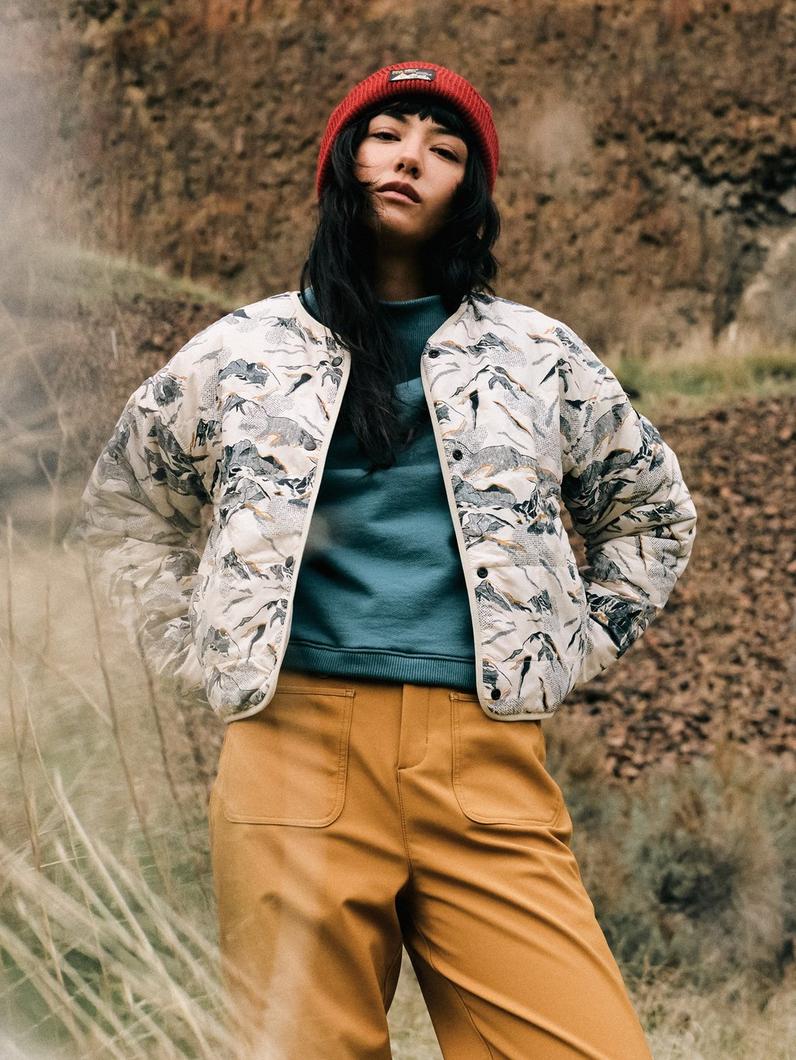 Fall New Arrivals with an image of people hiking through rocky terrain.