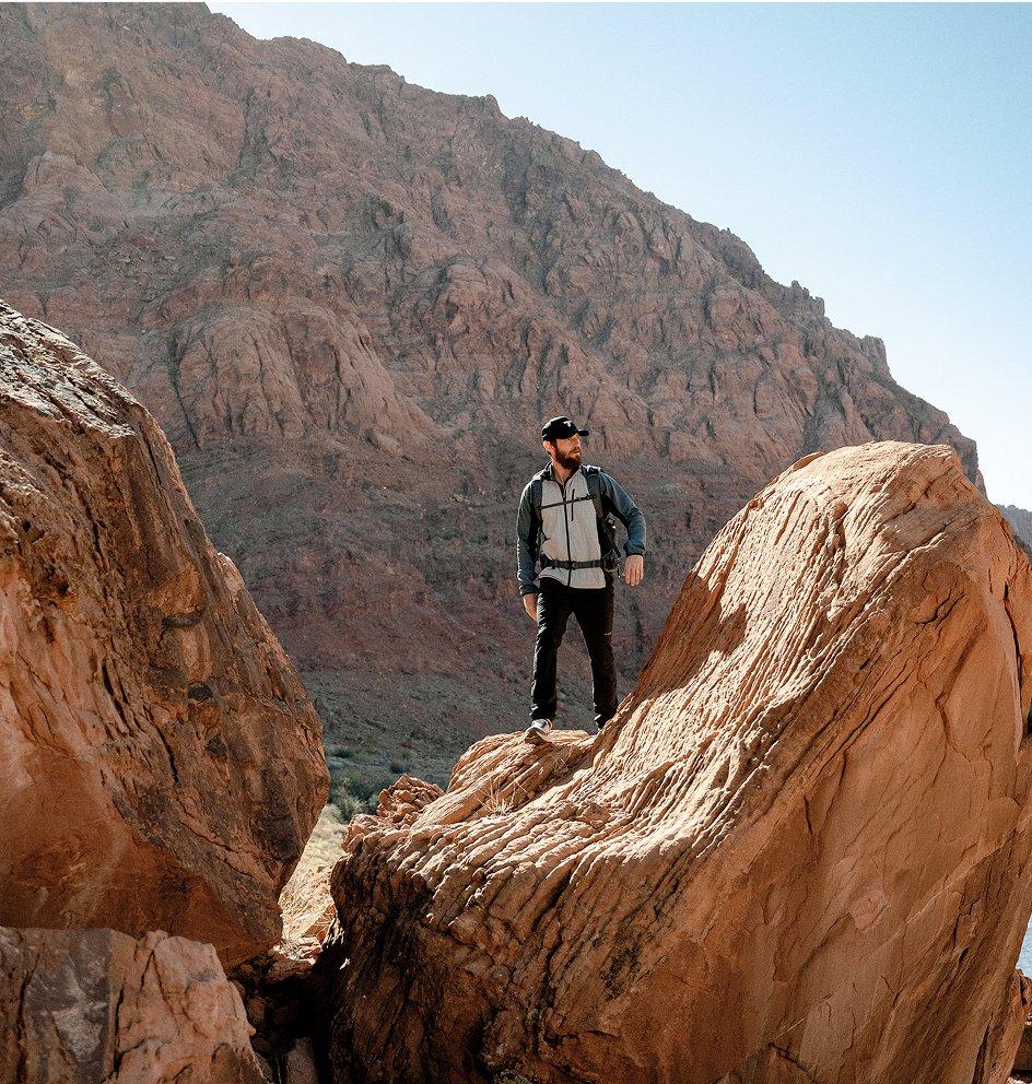 Lone hiker standing on a rock.