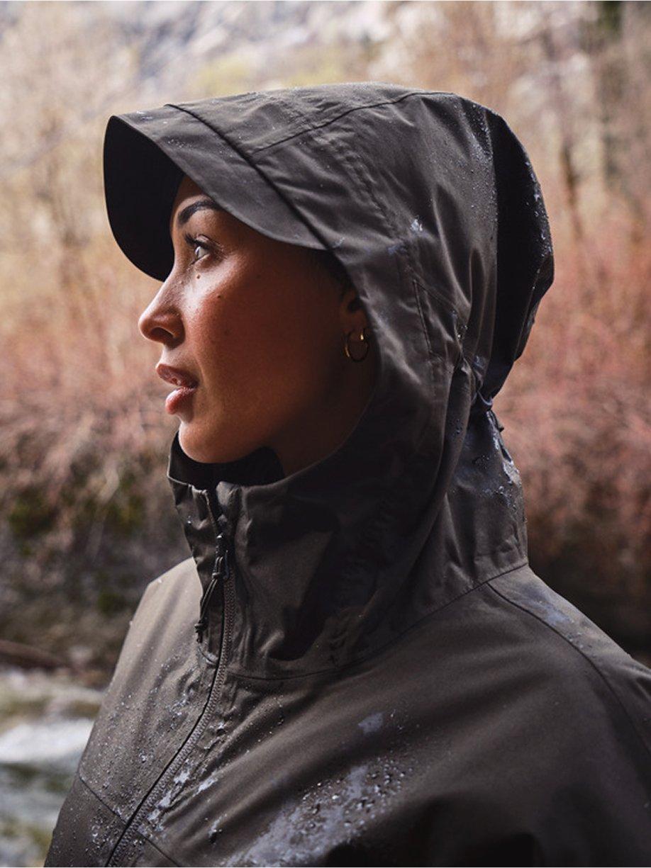 We've Got You Covered over a woman in wet weather wearing a rain jacket with the hood up.