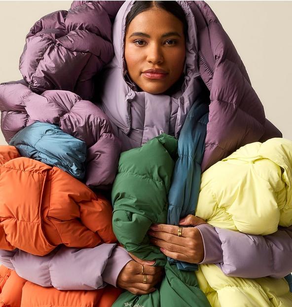 A woman wrapped up in a bunch of the Amaze Puff jackets.