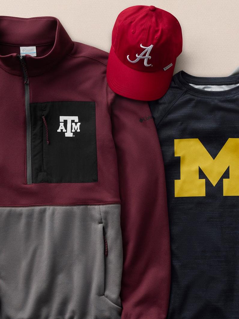 Flat lay of college apparel including a maroon zip jacket, red baseball cap, and navy t-shirt with logos.