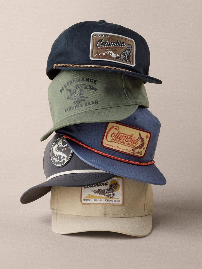 Stack of four baseball caps in various colors featuring outdoor-themed patches and embroidered designs.