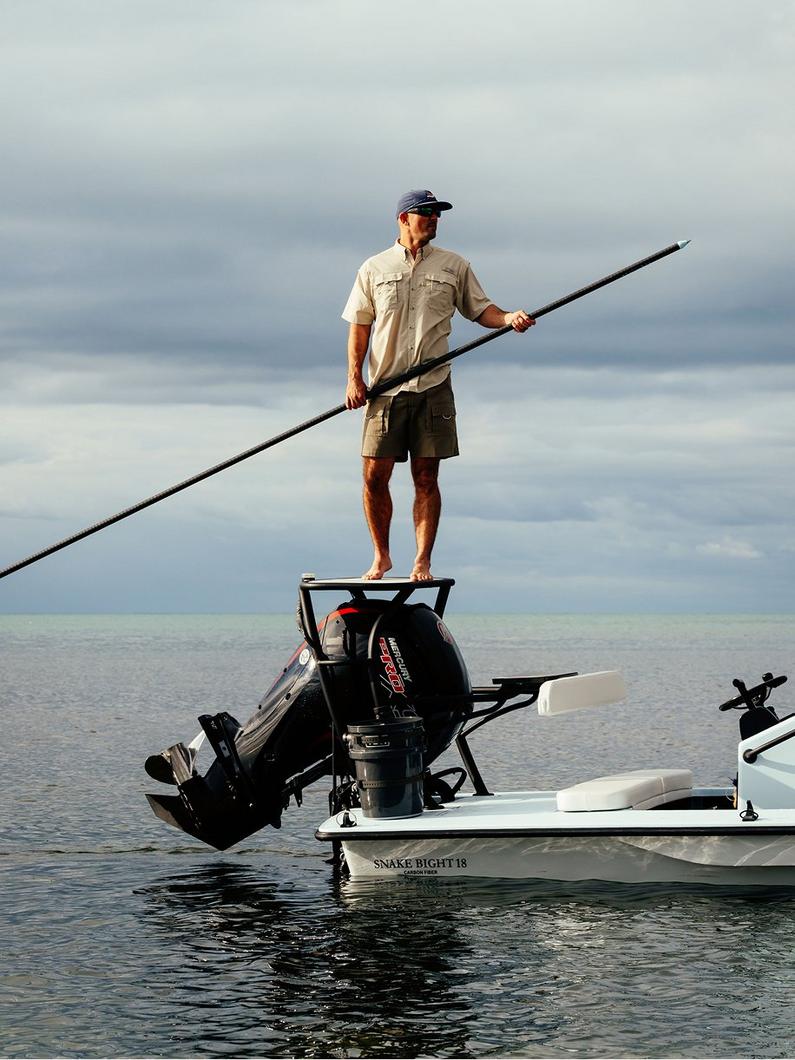 Man on a boat wearing a Bahama shirt.