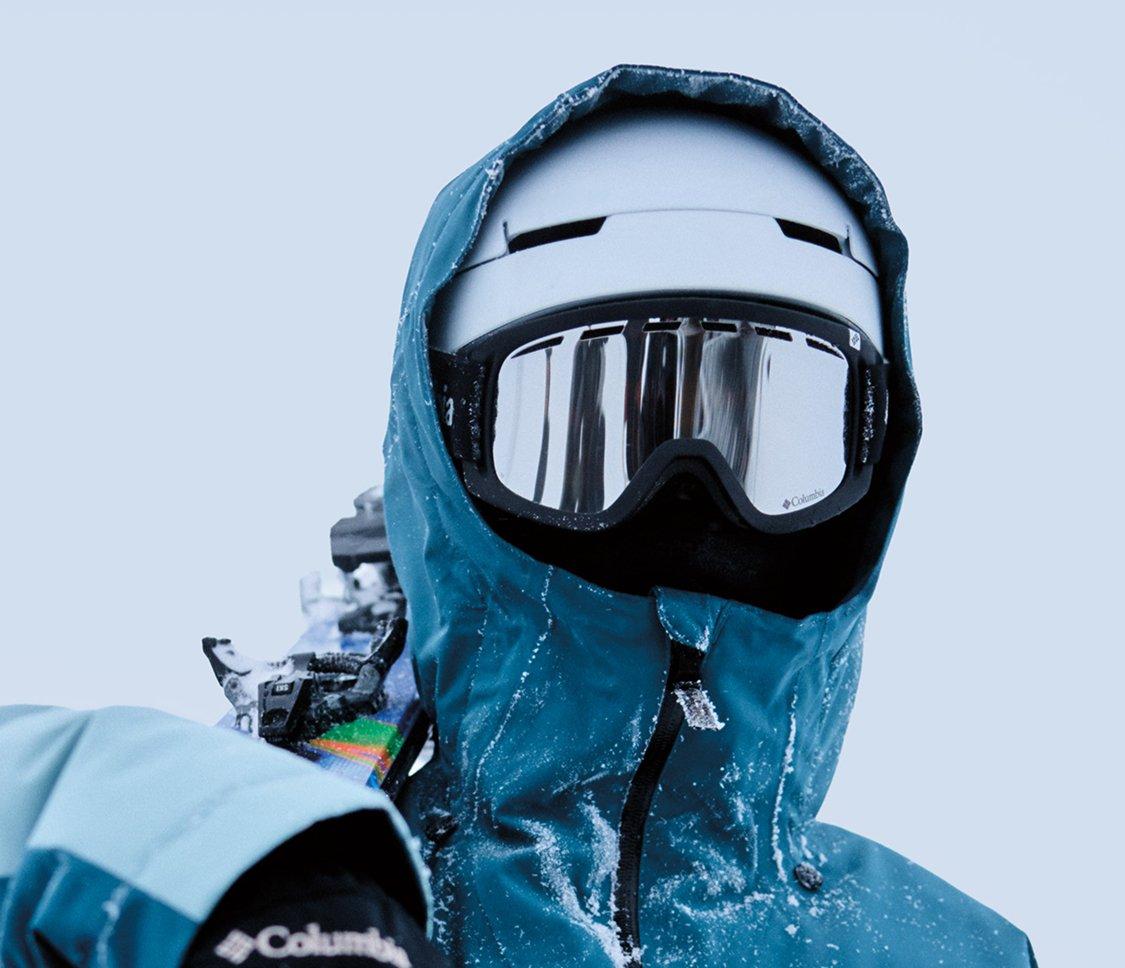 A skier wearing a blue kit, helmet, and goggles