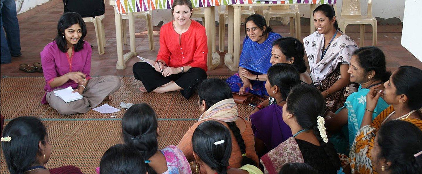 A group of Columbia female employees sitting in a circle during a workshop.