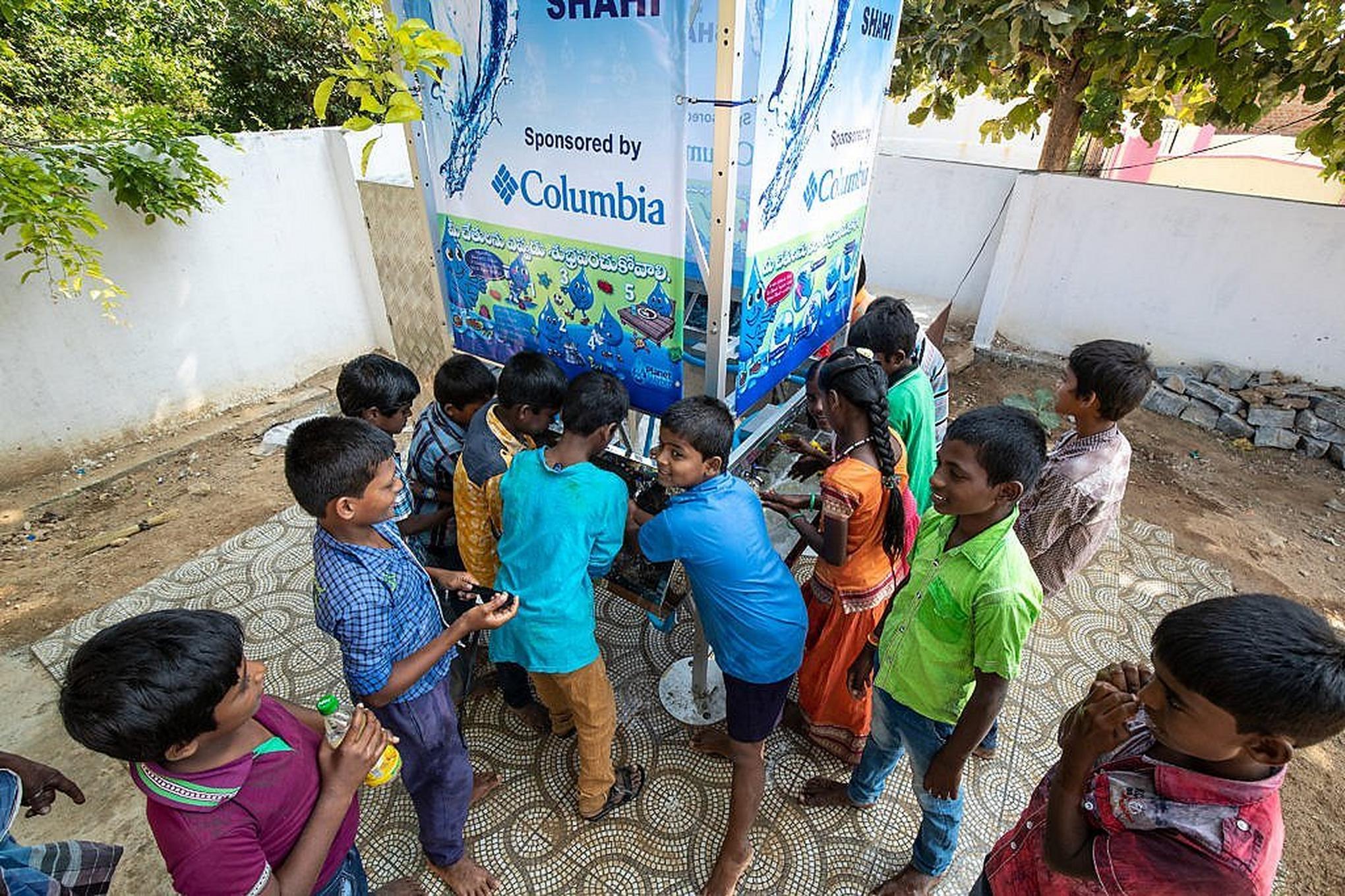 Kids gathered around clean water sinks.