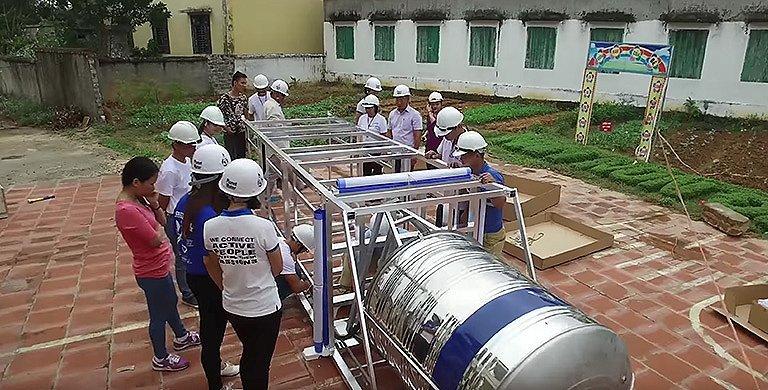 People in hardhats building materials for sustainable water usage. 