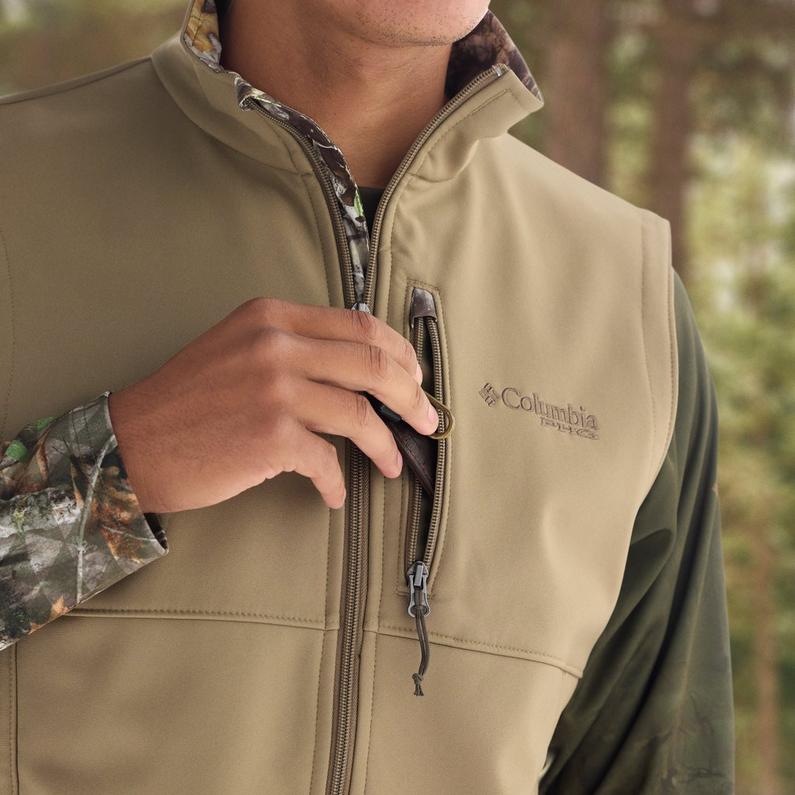 Model placing keys into the chest zip pocket.