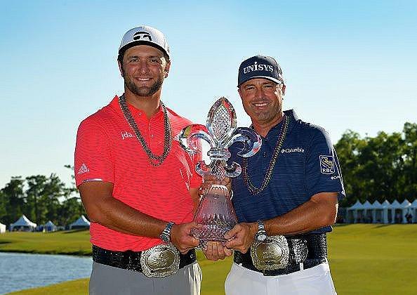 Jon Rahm and Ryan Palmer at the 2019 Zurich Classic holding a trophy. 