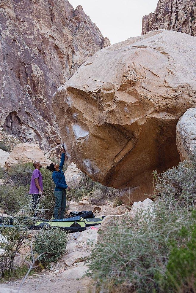 Caleb and Ayo Sopeju looking at a bouldering problem together