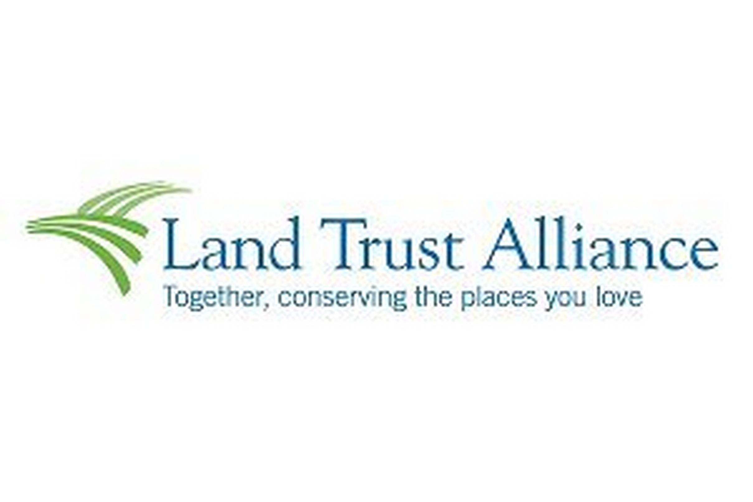 Logo featuring green curved lines resembling flowing grass or landscape contours with text "Land Trust Alliance Together, conserving the places you love".