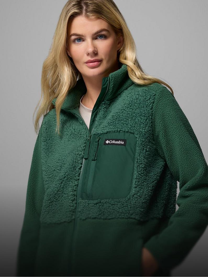 A woman wearing a light green fleece jacket.