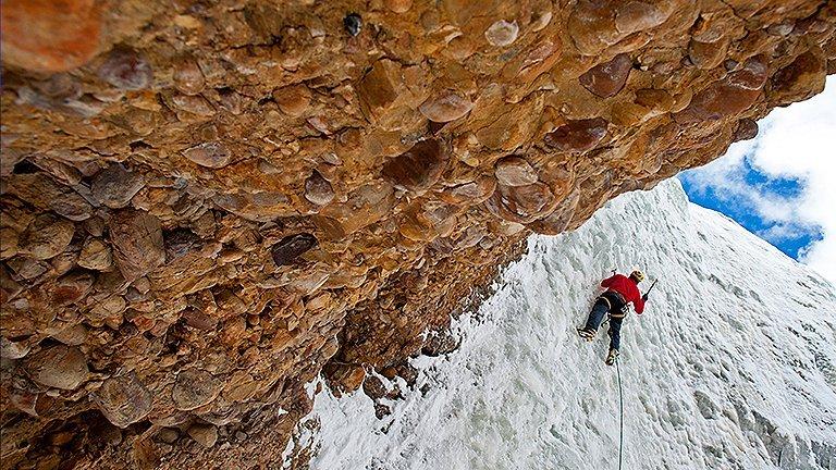 View of an ice climber making their way up the route