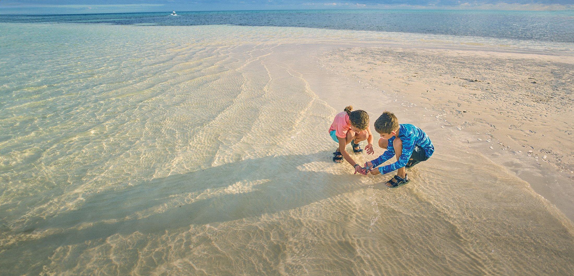 Two people walking through the snow in cozy fleece gear.
